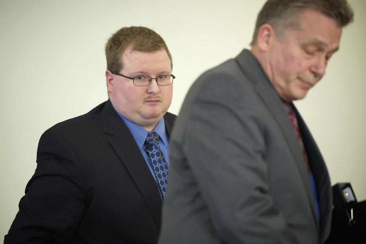 Sean Doucette, left, with his attorney Steven Thayer, walks from Judge Daniel Stahnke's courtroom this afternoon after charges of second-degree murder against him were dismissed.