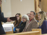 Schuyler Hoss, Southwest Washington representative for Gov. Jay Inslee, presents a  Washington state flag to the family of Air Force Capt.