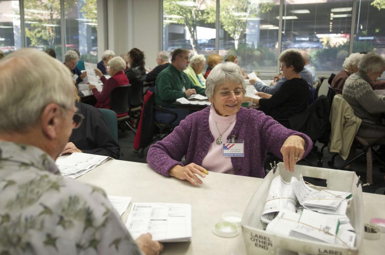 Clark County election official Darlene Hellbusch processes ballots on Oct. 29 at the Clark County Elections Office. Clark County hires 90 temporary election employees to sort, scan and inspect ballots.