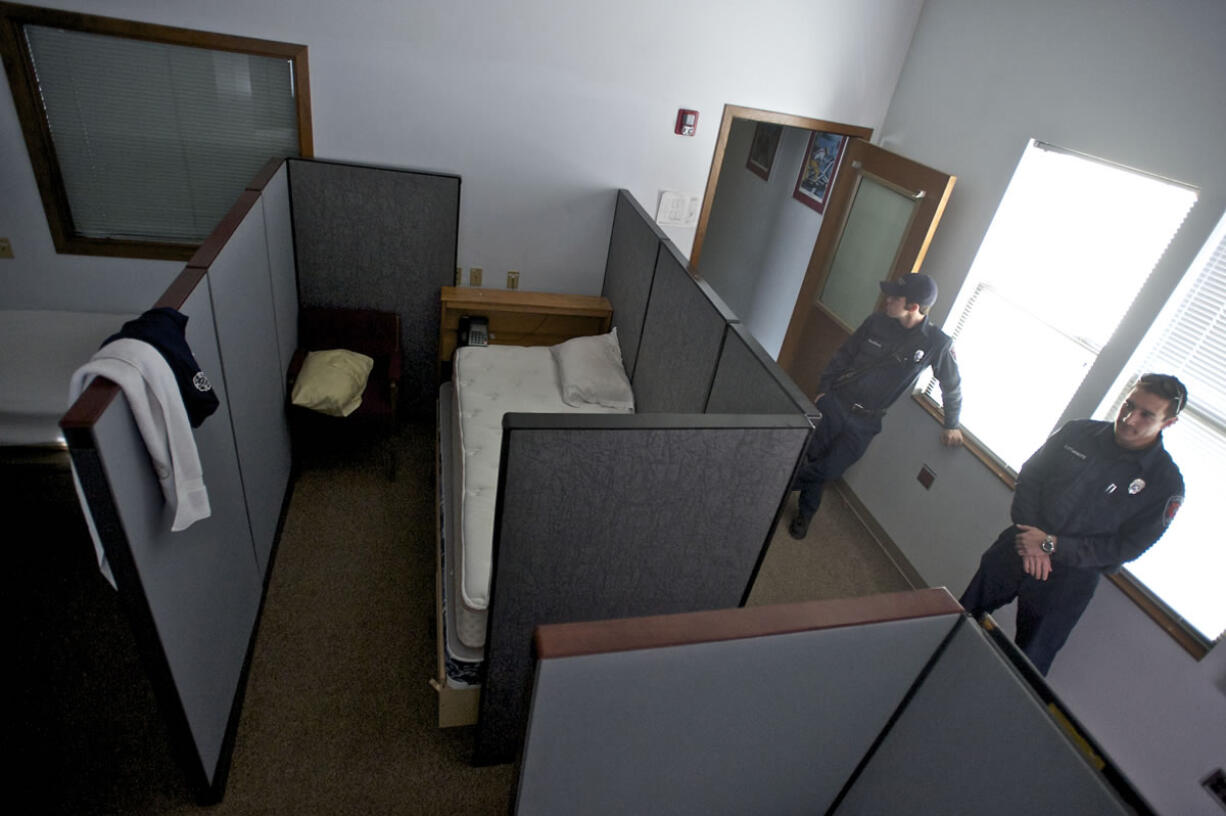 Firefighters Paul Bustamante, right, and Josh Haldeman walk through the living quarters of Clark County Fire and Rescue's Station 27.