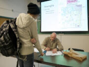 Clark College instructor Mark Bolke meets with student Margie Baron after a human anatomy and physiology class on the first day of winter term.