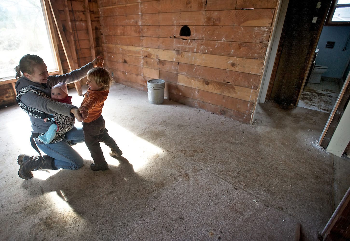 Patricia Kent shares a moment with her children Quintin, 2, and Cadence, 5 months, as she gives a tour of the property in east Clark County's Proebstel neighborhood she and her fiance hope to turn into their dream home.