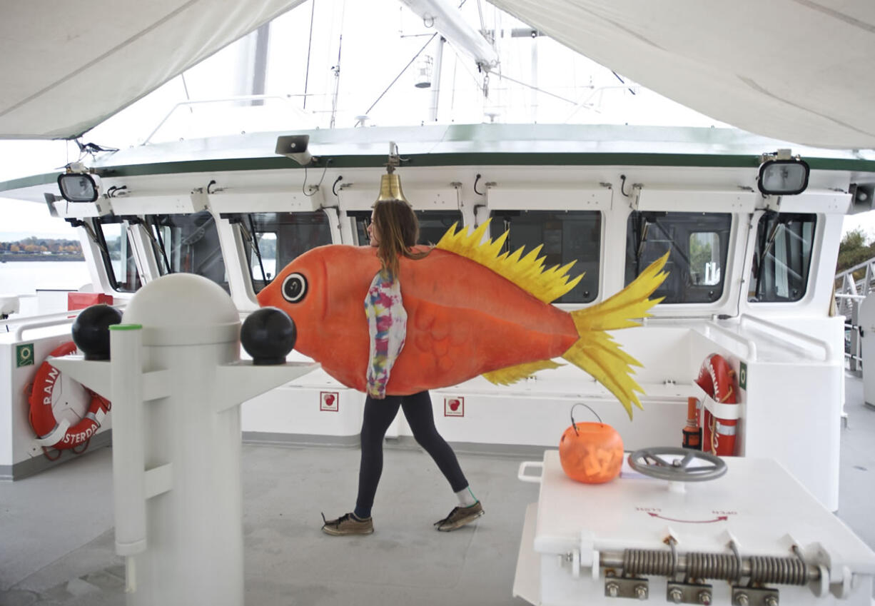 Greenpeace volunteer McKenzie Huso, 18, of Corvallis walks past the wheelhouse of the Rainbow Warrior in Vancouver on Wednesday.