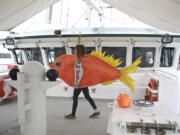 Greenpeace volunteer McKenzie Huso, 18, of Corvallis walks past the wheelhouse of the Rainbow Warrior in Vancouver on Wednesday.