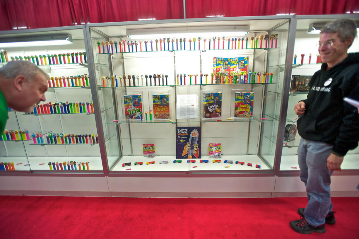 Alan Soles, right, talks on Sunday to Mark Junker of Portland about his Pez dispenser collection, which was on display at the Clark County Antique and Collectible Show at the Clark County Events Center at the Fairgrounds on Saturday and Sunday.