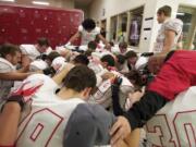 The Camas football team prays before its Class 4A quarterfinal game against Eastlake at Eastlake High School in Sammamish on Nov. 23.