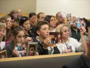 Supporters of Cadence Boyer hold photos of her as Duane C. Abbott, not pictured, the driver who struck and killed Cadence as she was trick-or-treating Halloween night 2014, enters guilty pleas Wednesday in Clark County Superior Court.