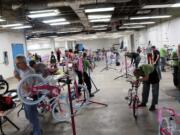 Columbia Way: Volunteers build hundreds of bikes on Dec. 5, part of Waste Connections' annual &quot;Christmas Promise&quot; program.