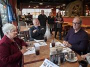 Mary Senescu, left, has a meal out with her husband, Larry, and new friends Gerry and Moira Quilling at the Mill Creek Pub. Gerry remains a great talker except when he has to fish for words; Larry is almost completely nonverbal but keeps flashing that wise smile. Behind the diners are Mill Creek Pub owner Russell Brent, Julie Williams of Home Instead Senior Care and Shanti Potts, a volunteer with the Elder Justice Center.