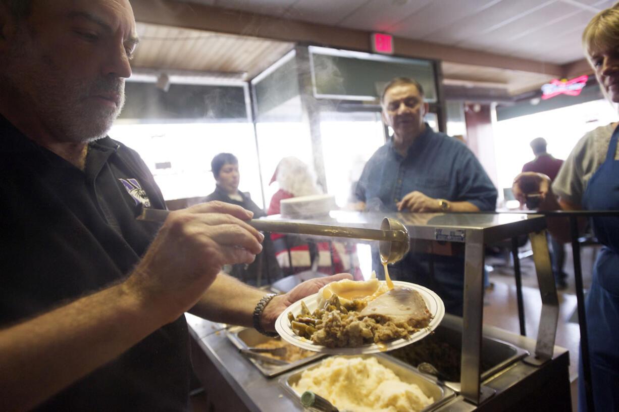 Clark County Judge Rich Melnick makes a plate for a guest at Chronis' free Thanksgiving meal in 2012.