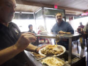 Clark County Judge Rich Melnick makes a plate for a guest at Chronis' free Thanksgiving meal in 2012.