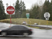 A series of signs provide information to motorists about onramps and offramps to Interstate 5 at Exit 11. It's possible a wrong-way driver entered there moments before a fatal crash on Feb. 28. At top, emergency crews work the scene of the Feb.