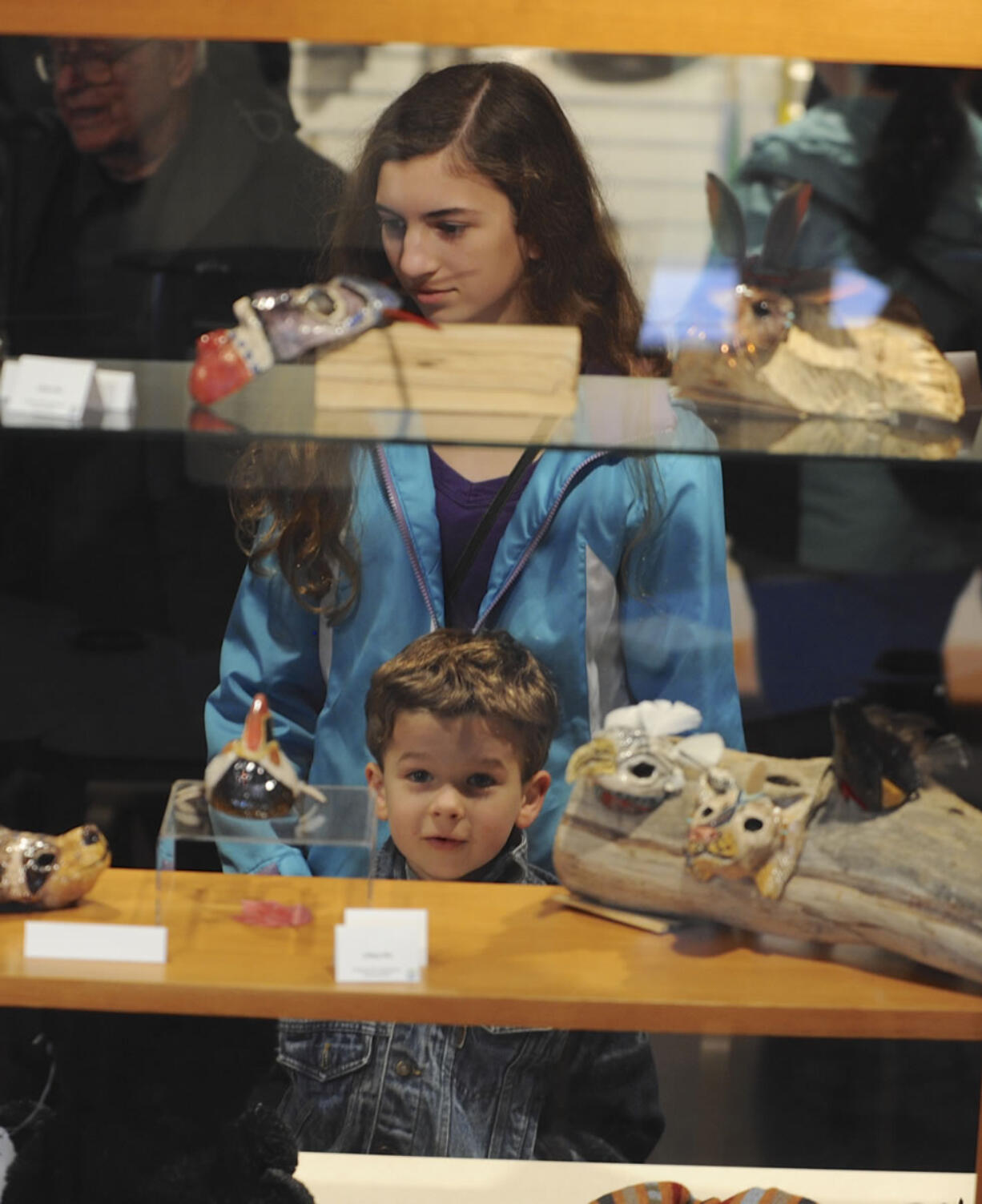 Rebekah Soft, top, and Reuben Soft examine artwork displayed at the grand reopening of the Fort Vancouver Visitor Center on Saturday.