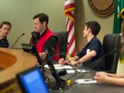 Students from St. Joseph's Nate Kutch, left, and Luke George, sit on the dais with Mayor Tim Leavitt as they participate in a mock city council debate at Vancouver City Hall on Friday. The kids playing councilors debate a proposed ban on pit bulls.