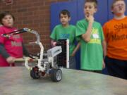 Splat Masters Tai McKinney, left, and Charlie Granlund prepare their Lego robot for competition.