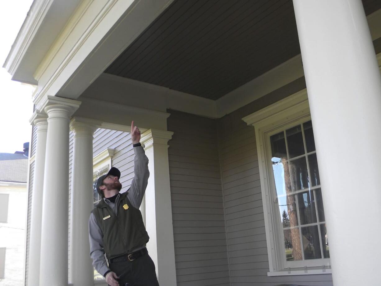 Alex Patterson, facility manager at Fort Vancouver National Historic Site, shows where porch repairs were made recently on the old headquarters building.