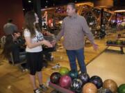 Clark County sheriff's Sgt. Shane Gardner talks with student Anji Dean, 16, while out bowling with the Explorer program earlier this year.