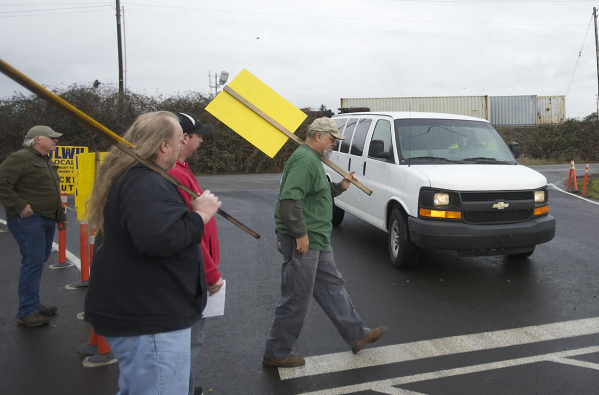 ILWU member Marcel DeBord walks in a crosswalk in front of a van entering the United Grain facility on Feb.