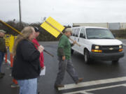 ILWU member Marcel DeBord walks in a crosswalk in front of a van entering the United Grain facility on Feb.