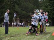 Blake Perkins of Washougal offers encouragement to participants as they take part in a team-building activity for eighth-grade boys Thursday afternoon at Jemtegaard Middle School.