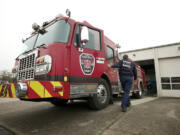 Camas firefighter Brad Delano pulls a fire engine out for routine inspection at Camas Station 41.