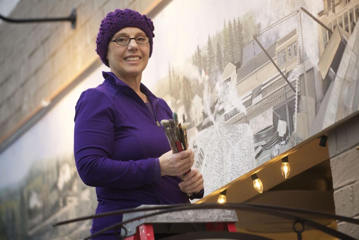 Camas artist Maria Grazia Repetto and her recently finished mural above the Camas Art Gallery.