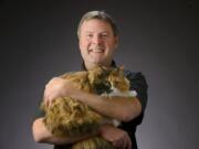 Scott Weissbeck and Mao, his Norwegian Forest cat. Mao was diagnosed with a rare disease earlier this year.