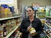 Galina Burley holds a jar of pickled apples as she talks about Russian party food at Anoush Deli in Vancouver.