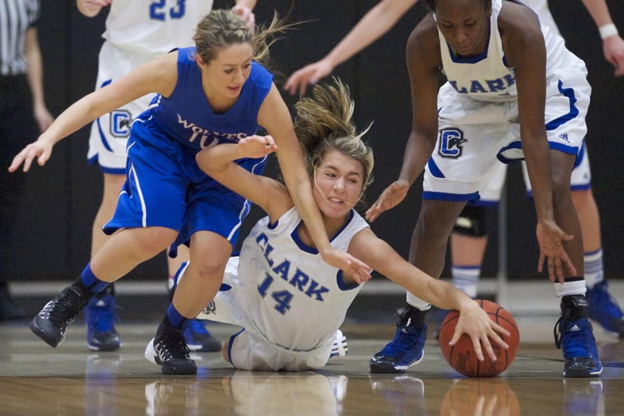 Clark College's Taylor Howlett dives for the ball against Blue Mountain Community College in the championship game of the 2013 Women's Basketball Crossover Tournament at Clark College, Sunday, December 22, 2013. Clark won 77-72.