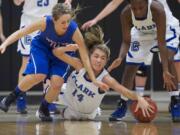 Clark College's Taylor Howlett dives for the ball against Blue Mountain Community College in the championship game of the 2013 Women's Basketball Crossover Tournament at Clark College, Sunday, December 22, 2013. Clark won 77-72.