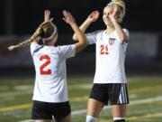 Perri Belzer (2), here greeting teammate Mason Minder (21), set up one of the two goals in the Papermakers&#039; 2-0 win over Lake Stevens on Tuesday.