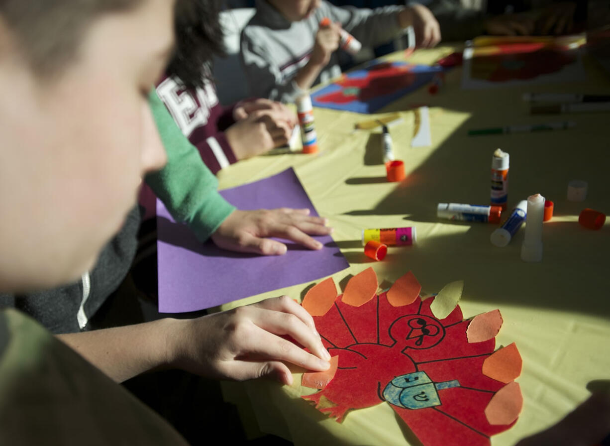 Jason Bernheimer, 13, works on a cross between a turkey and a menorah on Sunday  as he and other children at Congregation Kol Ami celebrate the fact that the first day of Hanukkah and Thanksgiving fall on the same day, making it Thanksgivukkah.