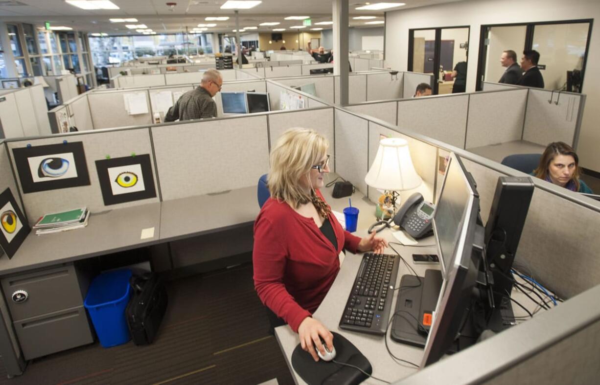 Business services consultant Marnie Farness gets settled into WorkSource&#039;s new offices, 204 S.E. Stone Mill Drive, on Monday.