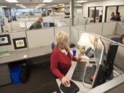 Business services consultant Marnie Farness gets settled into WorkSource&#039;s new offices, 204 S.E. Stone Mill Drive, on Monday.