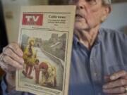 Vancouver veteran Paul Johnson holds a copy of a 1983 Columbian TV booklet.