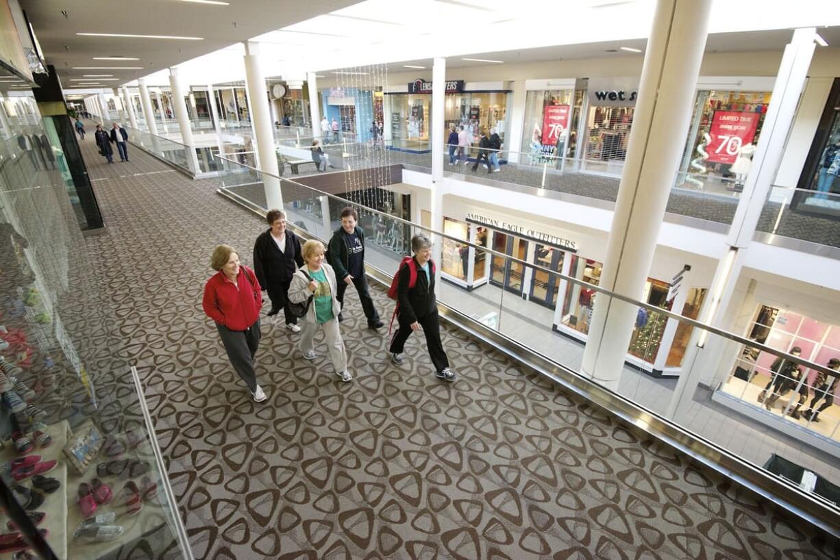 Shirley Hofmeister, 74, far right with backpack, leads the way for a group of walkers at Westfield Vancouver mall Nov. 21.