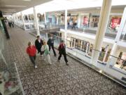 Shirley Hofmeister, 74, far right with backpack, leads the way for a group of walkers at Westfield Vancouver mall Nov. 21.