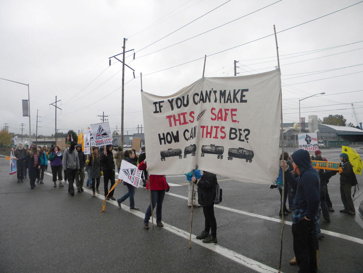 Demonstrators from Rising Tide, an environmental group with chapters in Portland and Vancouver, carried signs and chanted Monday morning in protest of an oil-transfer terminal proposed for the Port of Vancouver. About 50 people joined in the Monday morning event.