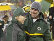 Brett Favre smiles with Bart Starr during a ceremony at halftime of an NFL football game between the Green Bay Packers and Chicago Bears Thursday, Nov. 26, 2015, in Green Bay, Wis. Favres retired No. 4 and name were unveiled inside Lambeau Field during the ceremony.