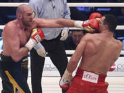 Britain&#039;s Tyson Fury, left, lands a punche to Ukraine&#039;s Wladimir Klitschko during their world heavyweight title fight on Saturday.