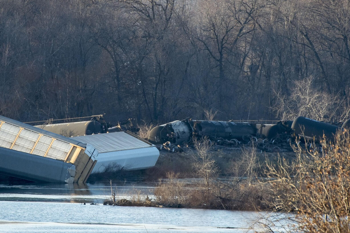 Train cars lie overturned outside of Alma, Wis. after derailing on Saturday. BNSF Railway said multiple tanker cars leaked ethanol into the Mississippi River on Saturday.