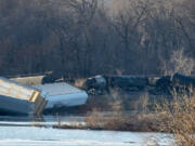 Train cars lie overturned outside of Alma, Wis. after derailing on Saturday. BNSF Railway said multiple tanker cars leaked ethanol into the Mississippi River on Saturday.