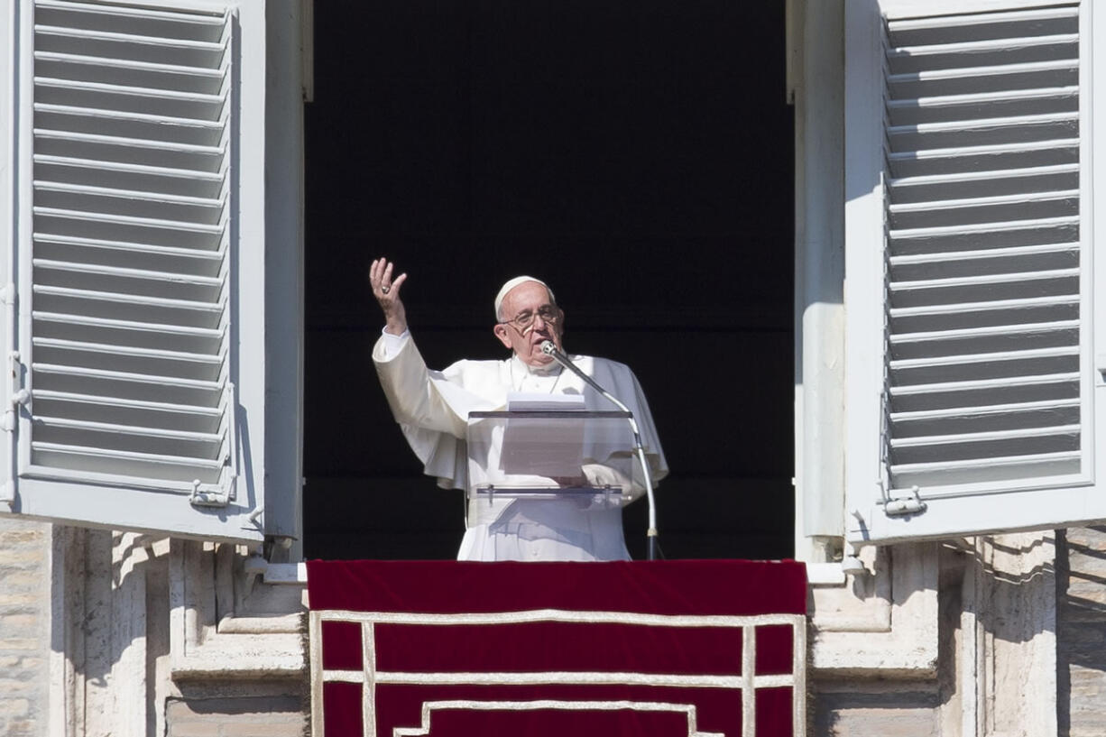 Pope Francis delivers his blessing during the Angelus noon prayer he celebrated from the window of his studio overlooking St. Peter&#039;s Square, at the Vatican on Sunday.