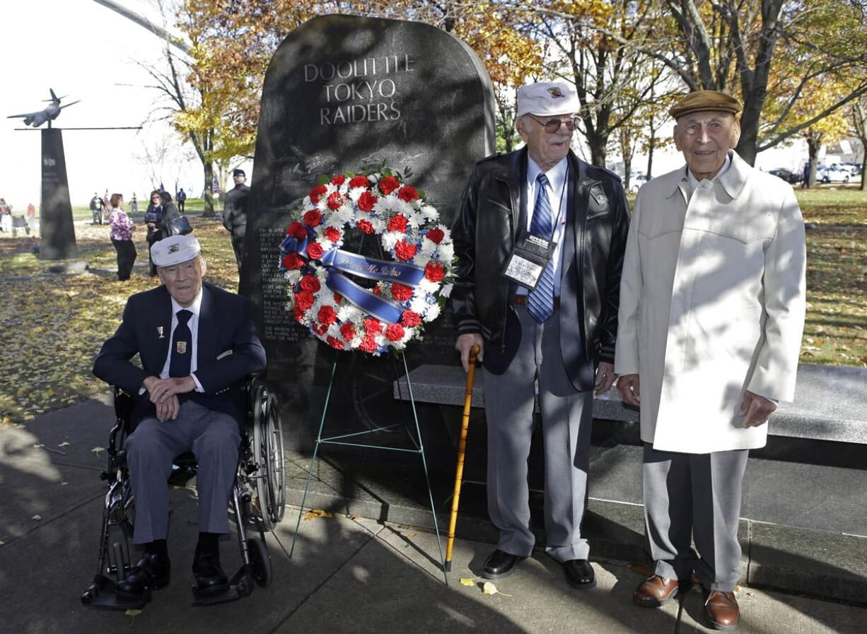 David Thatcher, from left, Edward Saylor, and Richard Cole, three of the four surviving members of the 1942 Tokyo raid led by Lt. Col. Jimmy Doolittle, pose Saturday at a monument marking the raid outside the National Museum for the U.S. Air Force in Dayton, Ohio.