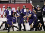 Washington's John Ross, left, returns a kickoff 100 yards for a touchdown against BYU during second quarter of the Fight Hunger Bowl at San Francisco.