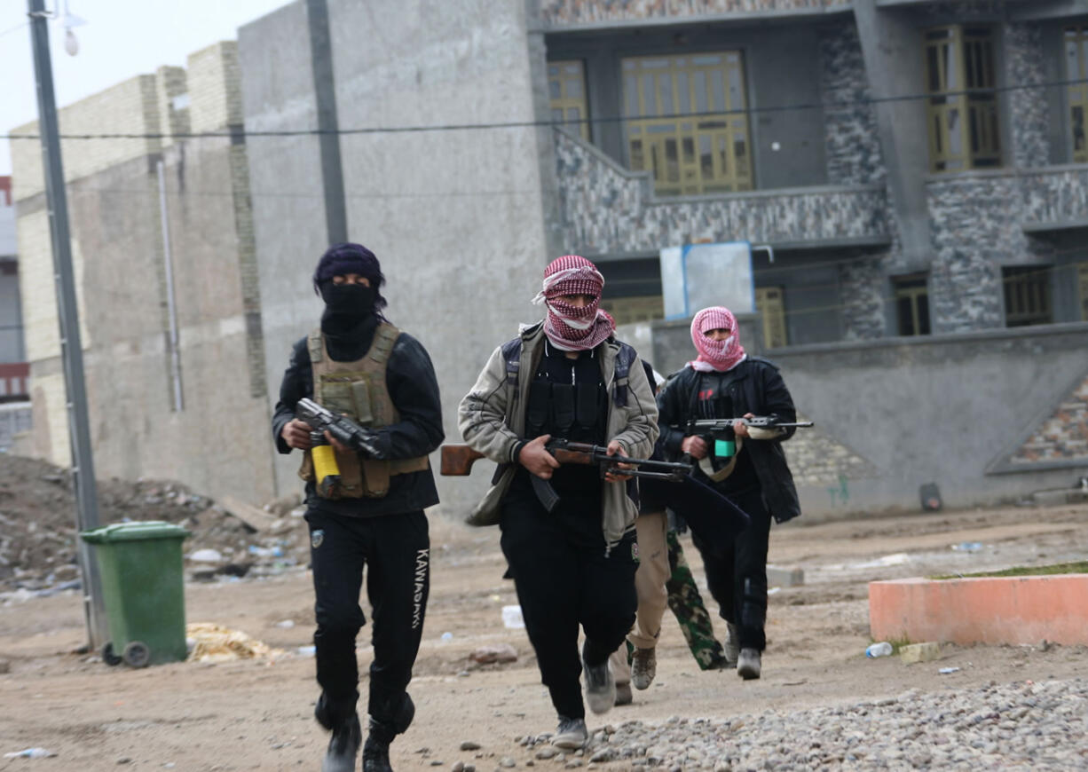 Gunmen patrol during clashes with Iraqi security forces Sunday in Fallujah, 40 miles west of Baghdad, Iraq. Lt. Gen.