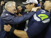 Seattle Seahawks head coach Pete Carroll celebrates with quarterback Russell Wilson after the host Seahawks won the NFC Championship Game 23-17 against the San Francisco 49ers.