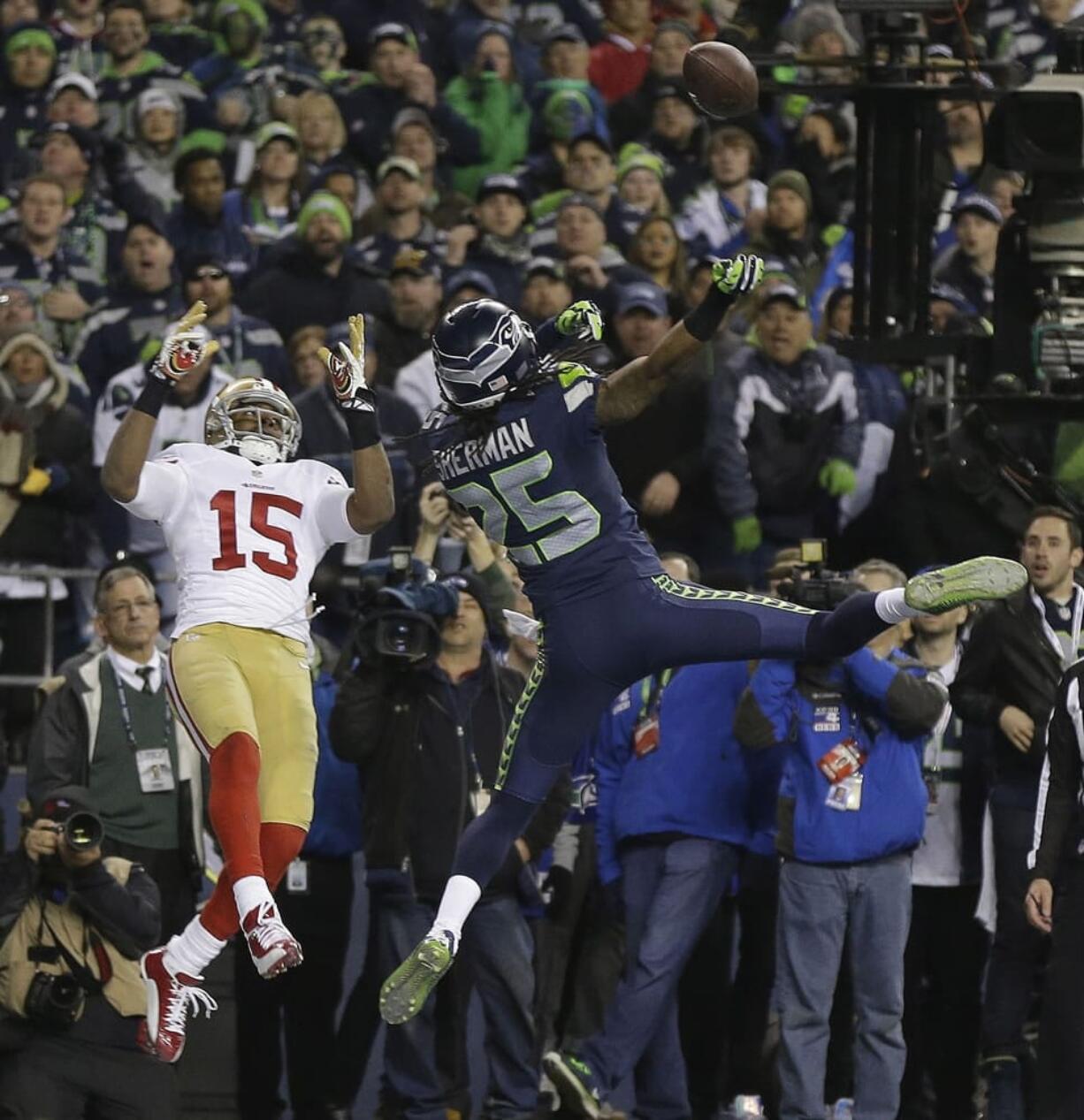 Seattle Seahawks' Richard Sherman tips a pass intended for San Francisco 49ers' Michael Crabtree (15) in the final seconds of the second half of the NFL football NFC Championship game Sunday, Jan. 19, 2014, in Seattle. Malcolm Smith intercepted the tipped pass. The Seahawks won 23-17 to advance to Super Bowl XLVIII.