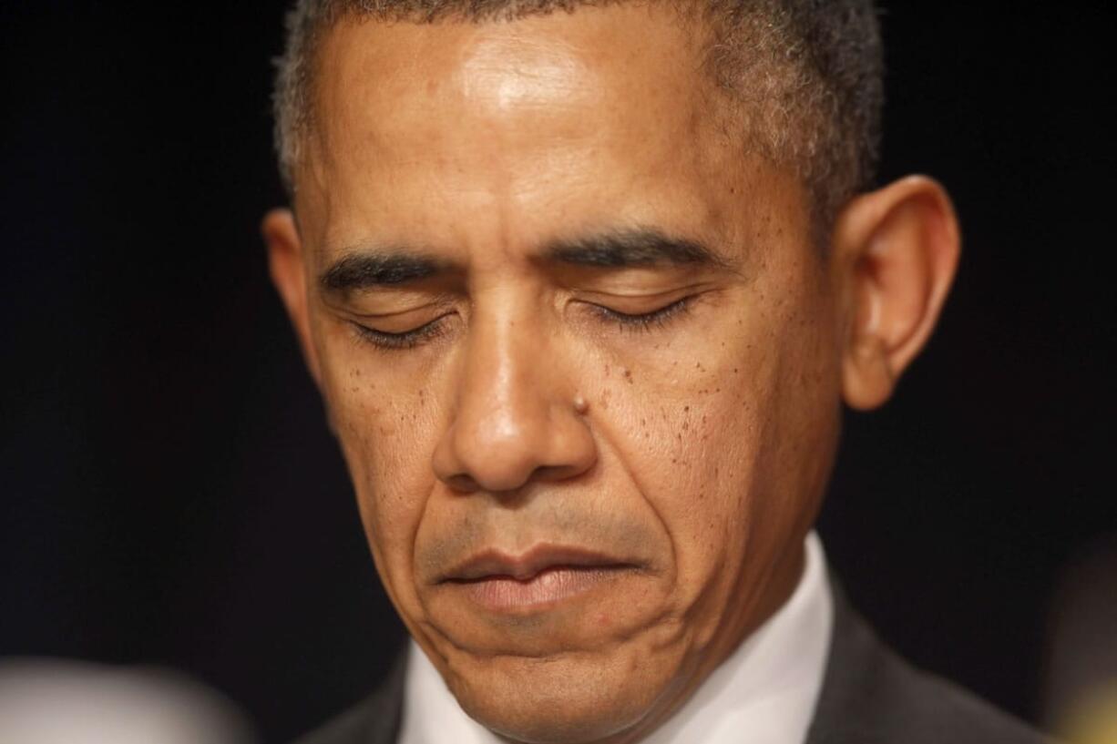 President Barack Obama closes his eyes as a prayer is offered at the National Prayer Breakfast in Washington on Thursday.