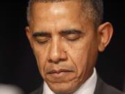 President Barack Obama closes his eyes as a prayer is offered at the National Prayer Breakfast in Washington on Thursday.